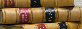 A stack of leather-bound legal case reporters