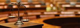 The scales of justice on a table in a courtroom